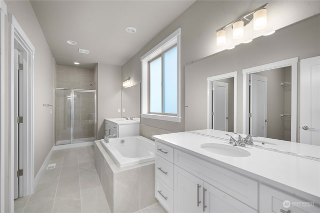 bathroom featuring vanity, tile patterned floors, and separate shower and tub