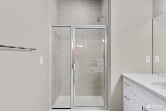 bathroom with vanity and a shower with shower door