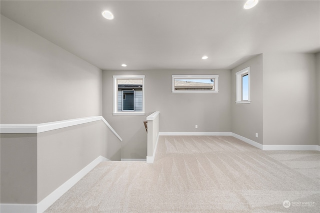 unfurnished room with light colored carpet