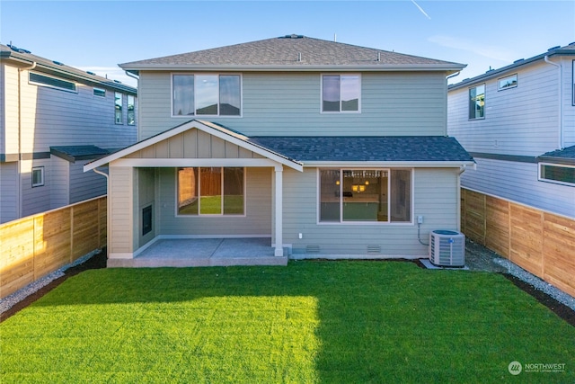 rear view of property featuring a patio area, a yard, and cooling unit