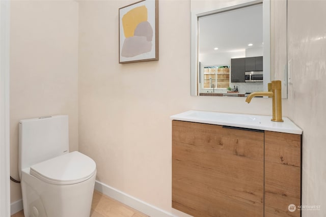 bathroom featuring vanity, toilet, and tile patterned floors