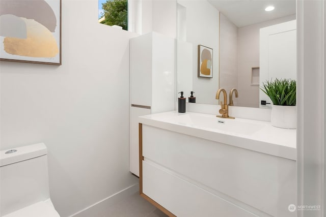 bathroom featuring toilet, vanity, and tile patterned floors