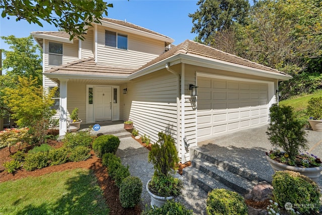 front of property with covered porch and a garage