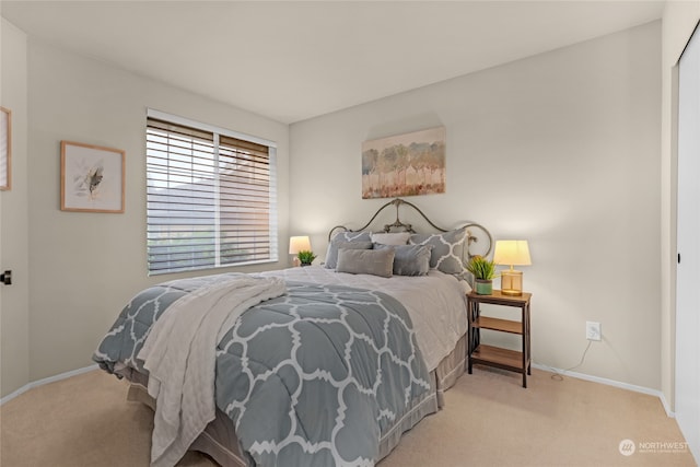 bedroom featuring light colored carpet