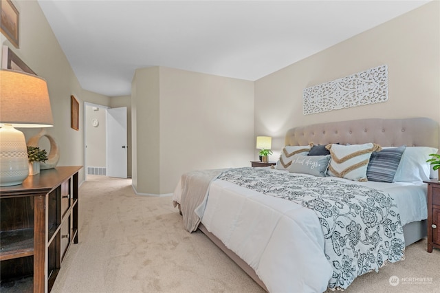 bedroom featuring light carpet