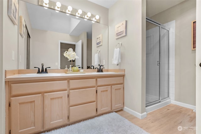 bathroom featuring vanity, hardwood / wood-style floors, and an enclosed shower