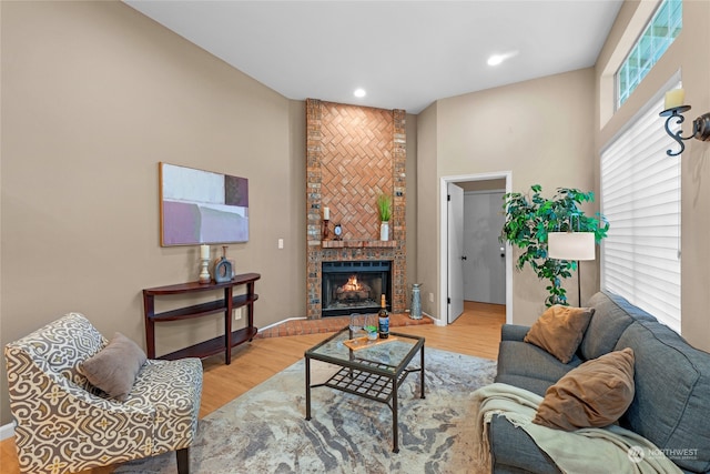 living room with a large fireplace and light hardwood / wood-style floors