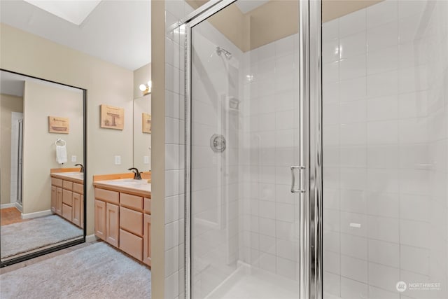 bathroom featuring vanity and an enclosed shower