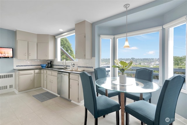 kitchen featuring hanging light fixtures, sink, radiator heating unit, backsplash, and dishwasher