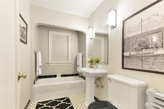 bathroom with toilet and a tub