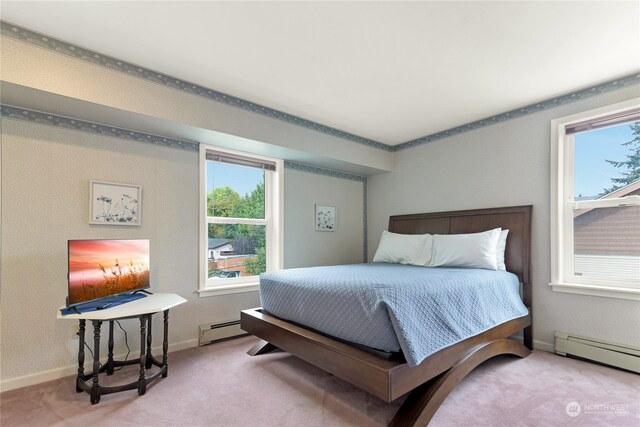 carpeted bedroom featuring a baseboard heating unit