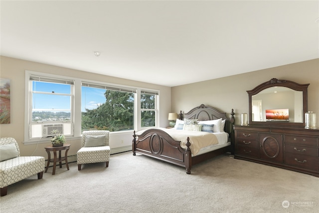 carpeted bedroom featuring multiple windows and baseboard heating