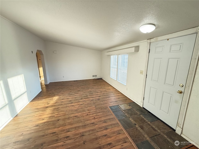 entryway featuring a textured ceiling and dark hardwood / wood-style flooring