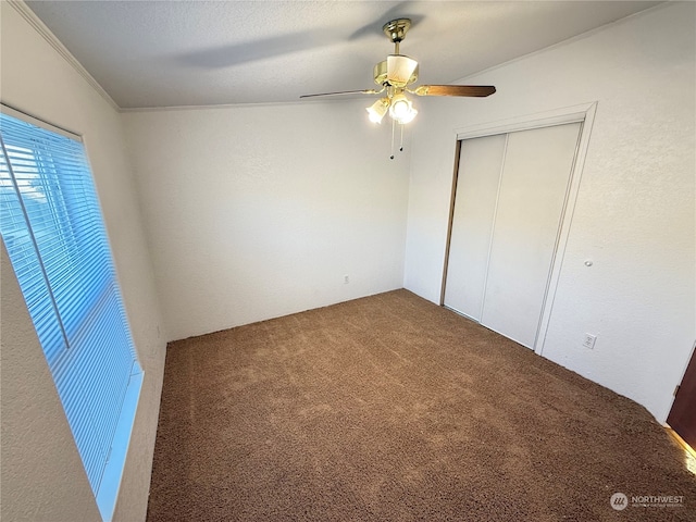 unfurnished bedroom featuring ceiling fan, carpet floors, and a closet