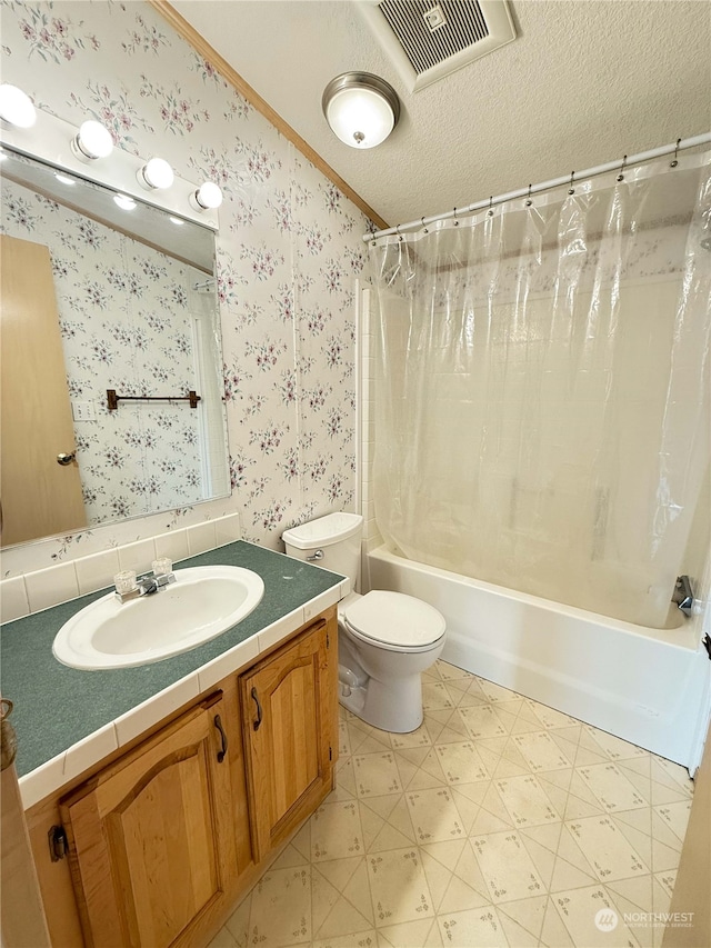 full bathroom featuring vanity, shower / bath combo, a textured ceiling, crown molding, and toilet