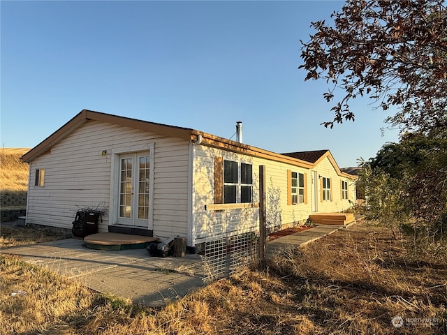 rear view of property featuring french doors and a patio