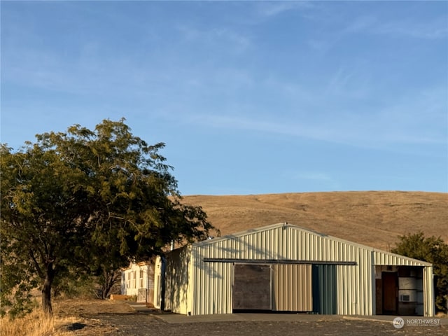 view of gate featuring an outbuilding