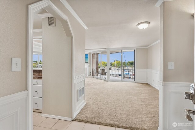 hall featuring crown molding and light carpet