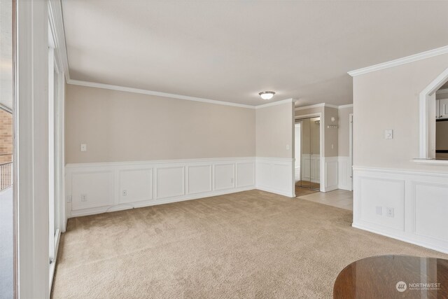 unfurnished living room featuring crown molding and light carpet