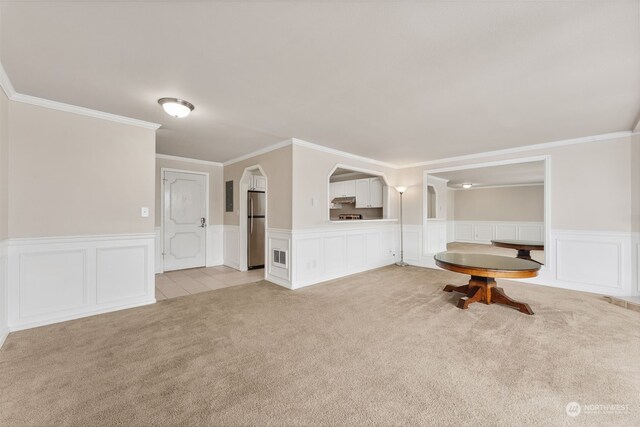 carpeted empty room with crown molding and electric panel