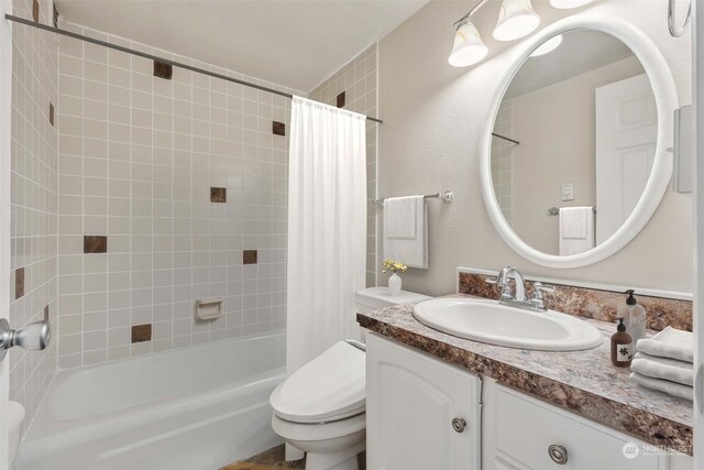 full bathroom featuring vanity, toilet, and shower / bath combination with curtain