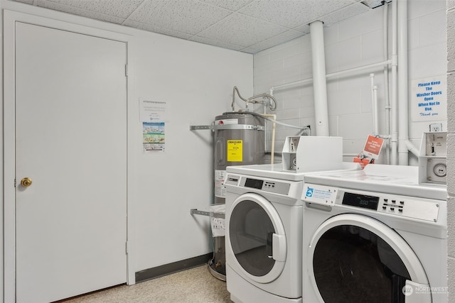 washroom with strapped water heater and separate washer and dryer