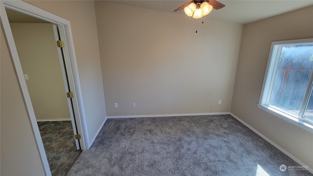 carpeted spare room with ceiling fan