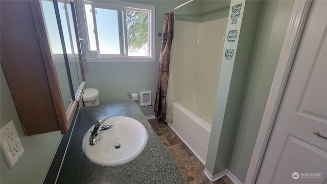 full bathroom with shower / bath combination with curtain, sink, and toilet