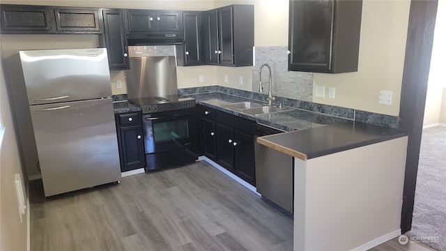 kitchen with stainless steel appliances, hardwood / wood-style floors, and sink