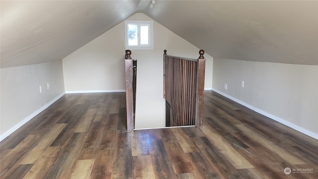 bonus room featuring lofted ceiling and dark hardwood / wood-style flooring