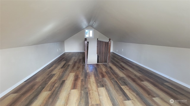 bonus room with vaulted ceiling and dark hardwood / wood-style flooring