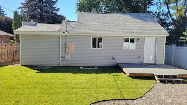 back of property featuring a deck and a yard