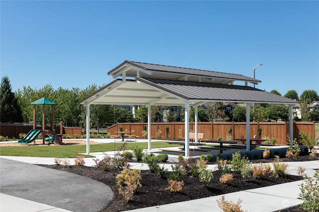 view of property's community featuring a yard and a playground