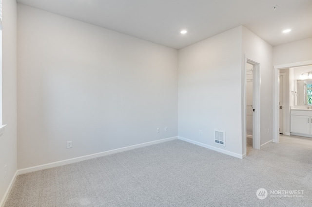 empty room featuring light colored carpet