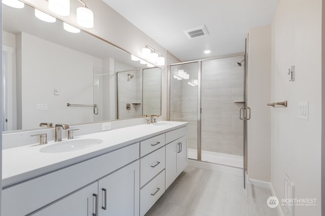 bathroom with vanity and an enclosed shower