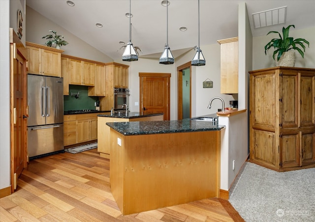 kitchen featuring high quality fridge, light hardwood / wood-style floors, pendant lighting, and sink