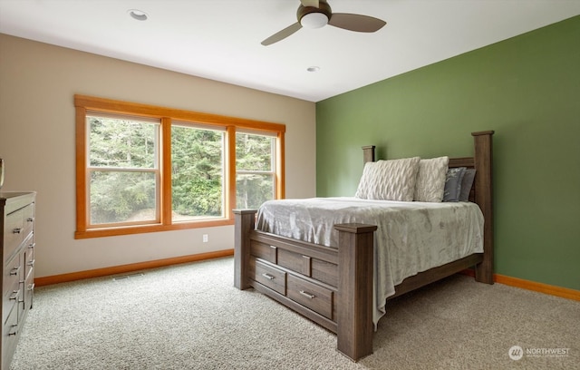 bedroom with ceiling fan and light colored carpet