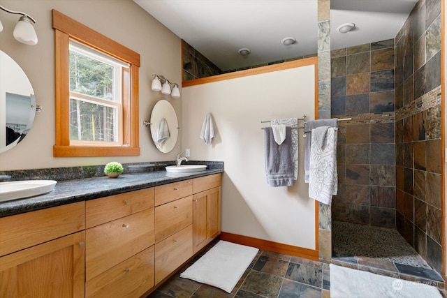 bathroom featuring vanity and tiled shower