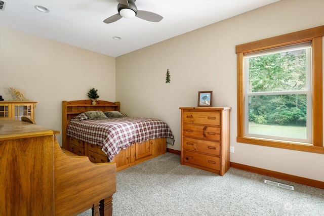 bedroom featuring light carpet and ceiling fan