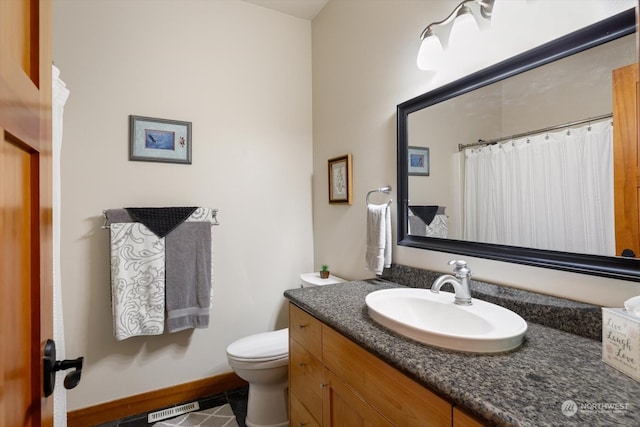 bathroom with vanity and toilet