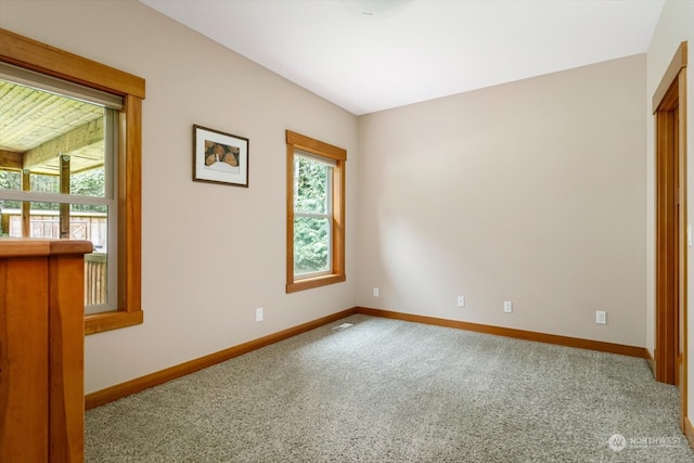 unfurnished room featuring light carpet