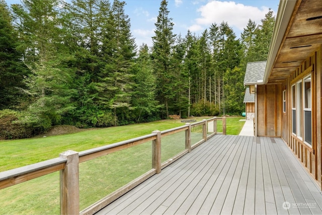 wooden terrace with a lawn