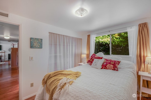 bedroom with hardwood / wood-style flooring