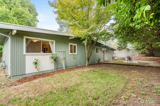 view of home's exterior featuring a yard and a patio area