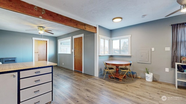 kitchen with ceiling fan, a textured ceiling, and light hardwood / wood-style flooring