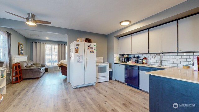 kitchen featuring white appliances, white cabinetry, tasteful backsplash, light hardwood / wood-style floors, and sink