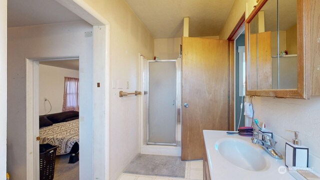 bathroom featuring an enclosed shower and vanity