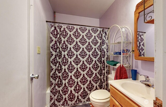 full bathroom with toilet, vanity, and shower / bath combination with curtain