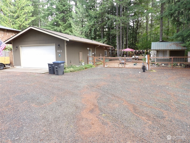 view of property exterior with a garage and an outbuilding