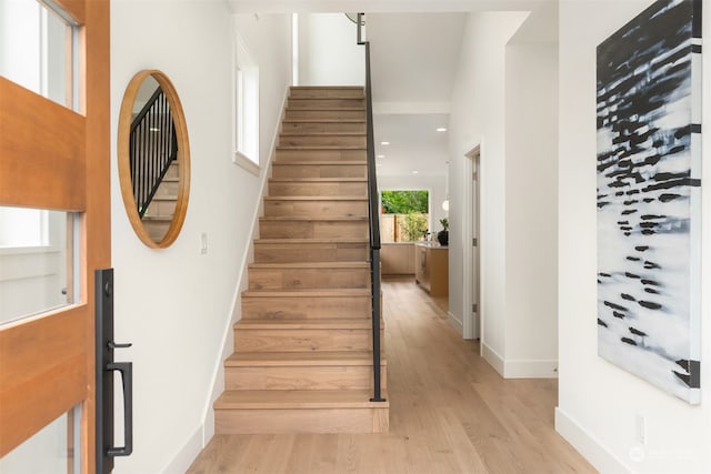 stairs featuring wood-type flooring